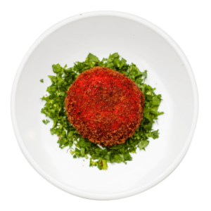 Baked Mashed Potato surrounded in chopped parsley on a round white plate