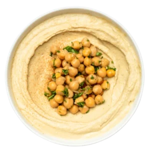 Classic Hummus dip with chickpeas in the center in a white bowl