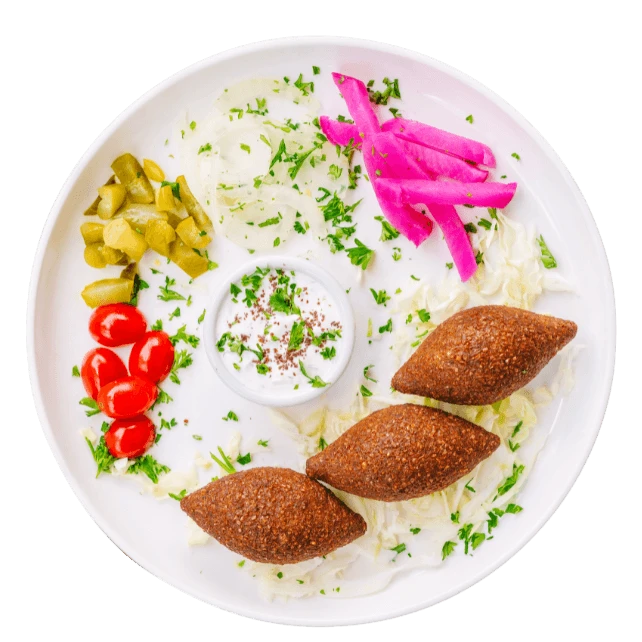 Kibbeh Lebanese fried beef croquettes made with halal beef, served with pickled turnips and garlic sauce at Aladdin Mediterranean Cuisine in Houston