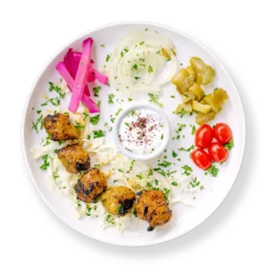 Filet Lamb Kabob with pickles tomatoes and cabbage and garlic sauce Aladdins Houston