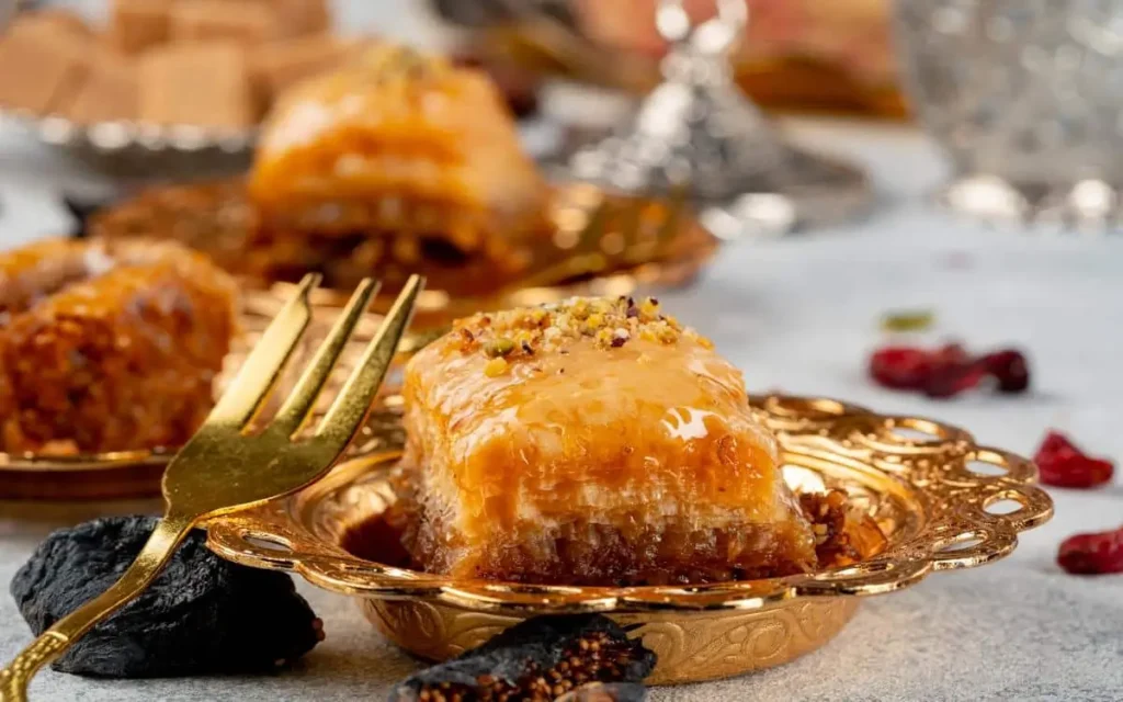 Assorted Turkish baclawa served with tea on an elegant silver tray.