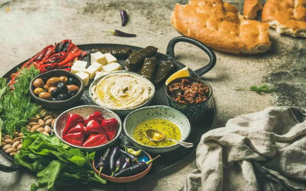 traditional Mezze Platter Stuffed Grape Leaves, Olives, and Creamy Hummus
